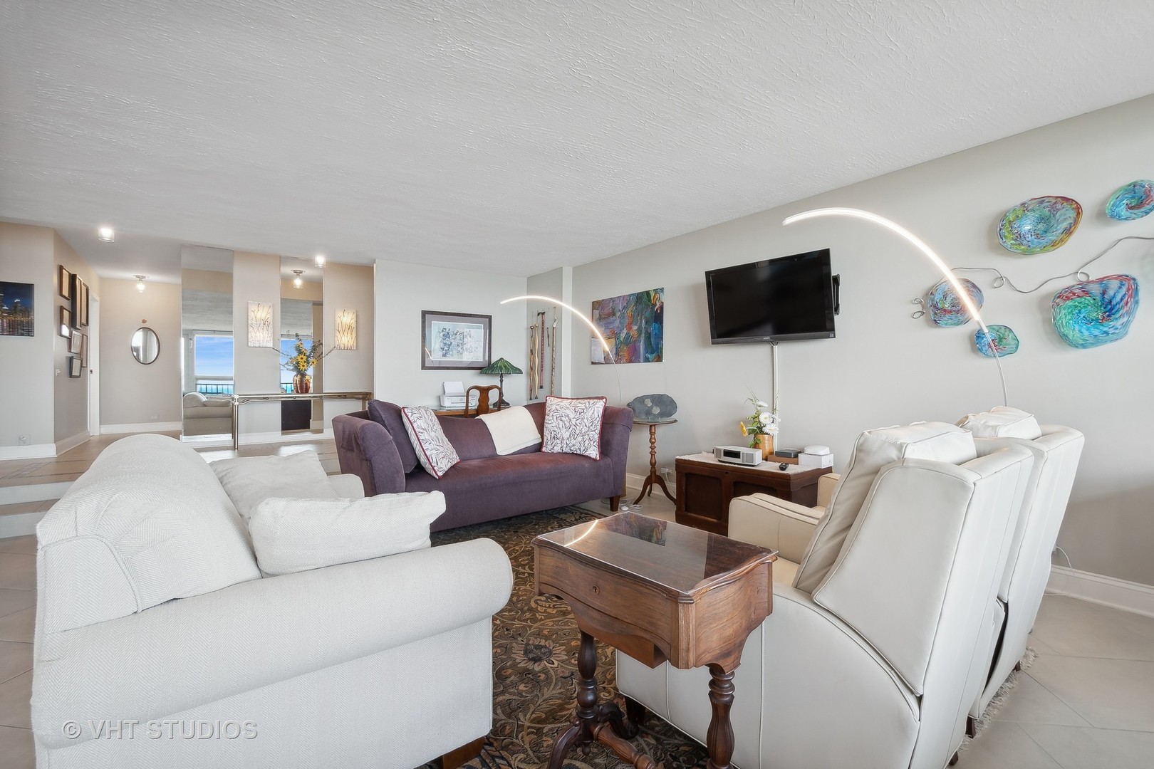 5733 North Sheridan Road, Unit 16A Chicago, IL 60660 - Photo 9 of 29 a living room with furniture and a flat screen tv