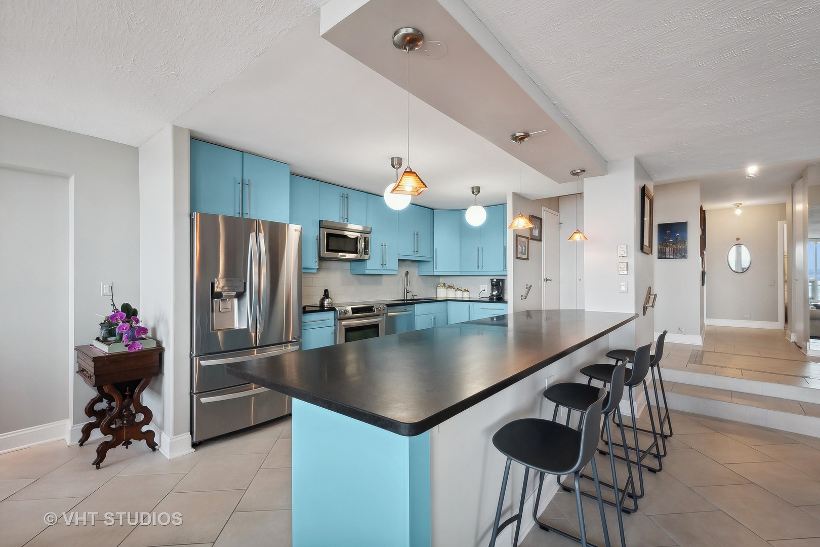 5733 North Sheridan Road, Unit 16A Chicago, IL 60660 - Photo 10 of 29 a kitchen with stainless steel appliances granite countertop a sink a refrigerator and a stove