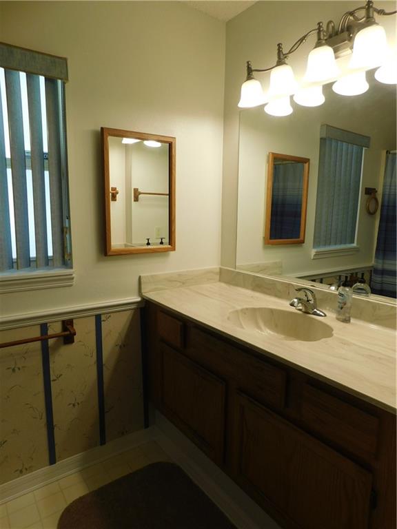 7601 Pensacola Road Fort Pierce, FL 34951 - Photo 10 of 14 a bathroom with a double vanity sink and a mirror