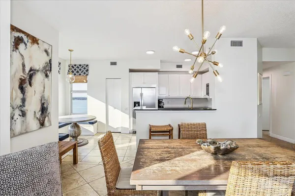 a spacious bedroom with a bed a dresser and a large mirror