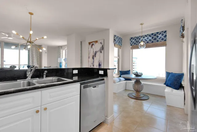 a kitchen with a sink and white cabinets