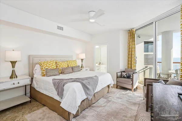 a bedroom with a bed and a painting on the wall