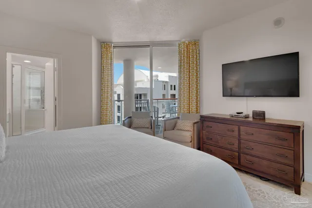 a dining room with furniture and a floor to ceiling window