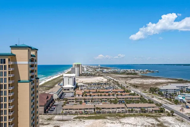 a bedroom with two beds and painting on the wall