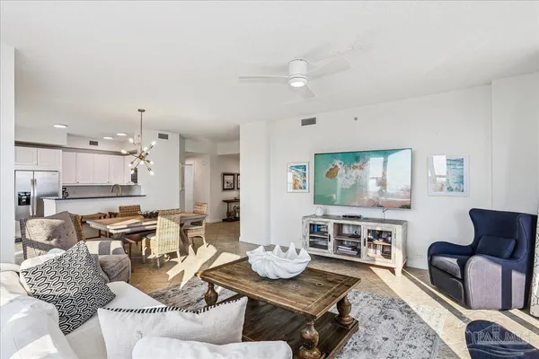 a living room with stainless steel appliances kitchen island granite countertop furniture and a living room
