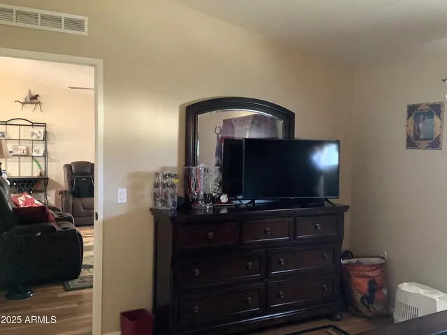 a kitchen with a refrigerator and a wooden cabinets