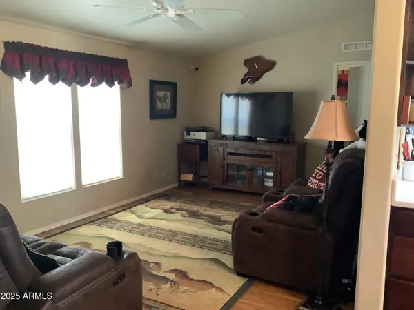 a living room with furniture a rug and a chandelier