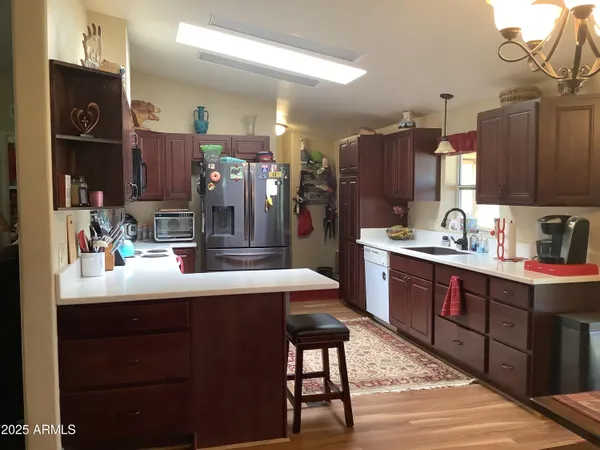 a kitchen with a refrigerator and a sink