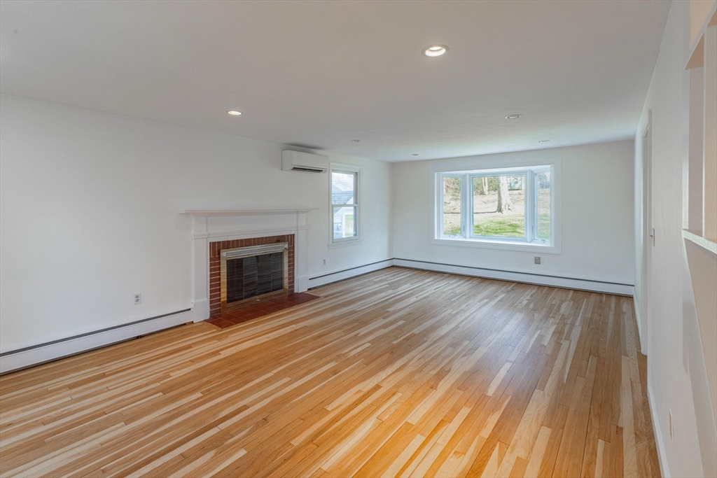 41 Labor In Vain Road Ipswich, MA 01938 - Photo 11 of 33 an empty room with windows and fireplace