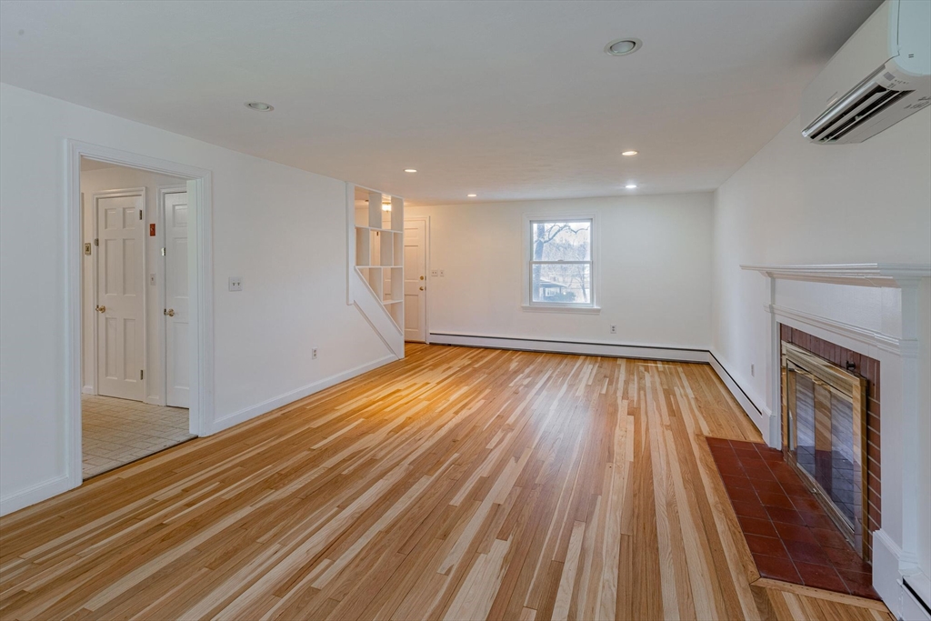 41 Labor In Vain Road Ipswich, MA 01938 - Photo 12 of 33 a view of empty room with wooden floor and fireplace