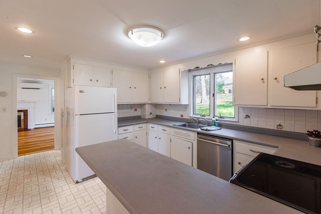 41 Labor In Vain Road Ipswich, MA 01938 - Photo 15 of 33 a kitchen with a sink a refrigerator and white cabinets
