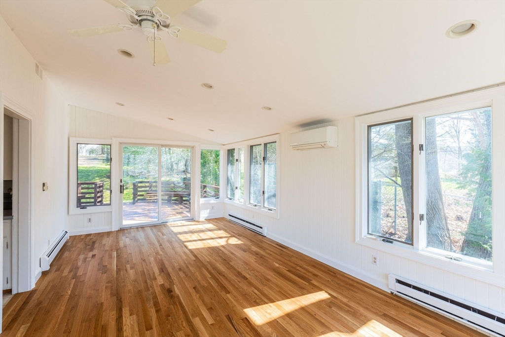 41 Labor In Vain Road Ipswich, MA 01938 - Photo 21 of 33 a view of an empty room with a window and wooden floor