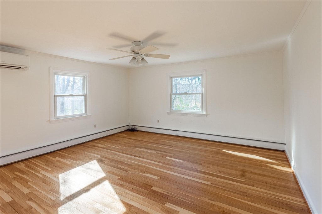 41 Labor In Vain Road Ipswich, MA 01938 - Photo 22 of 33 a view of an empty room with a window and wooden floor