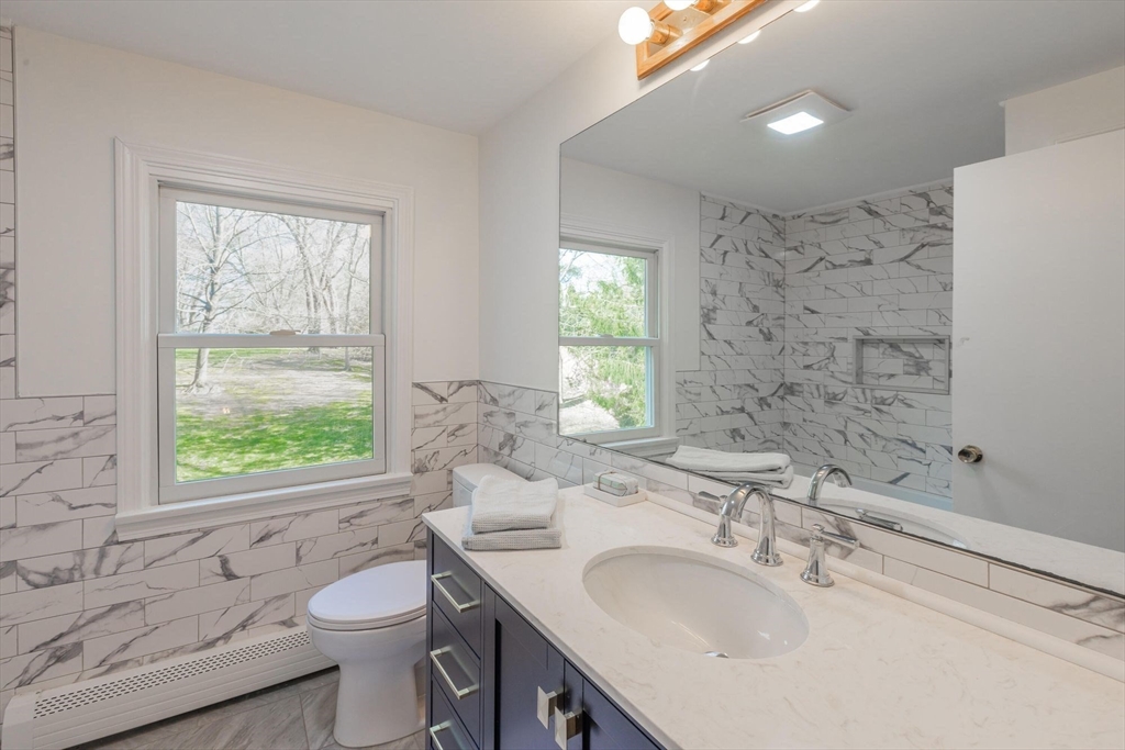 41 Labor In Vain Road Ipswich, MA 01938 - Photo 23 of 33 a bathroom with a sink toilet a mirror and window