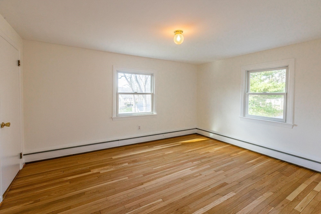 41 Labor In Vain Road Ipswich, MA 01938 - Photo 26 of 33 wooden floor in an empty room with a window