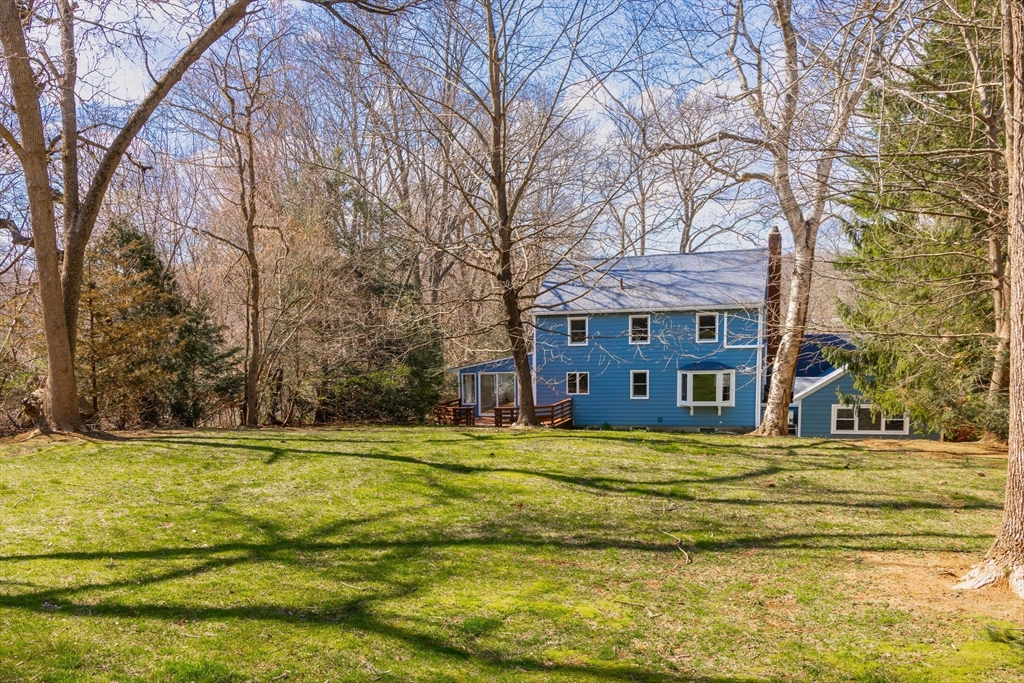 41 Labor In Vain Road Ipswich, MA 01938 - Photo 4 of 33 a view of a swimming pool with a lawn chairs under an umbrella