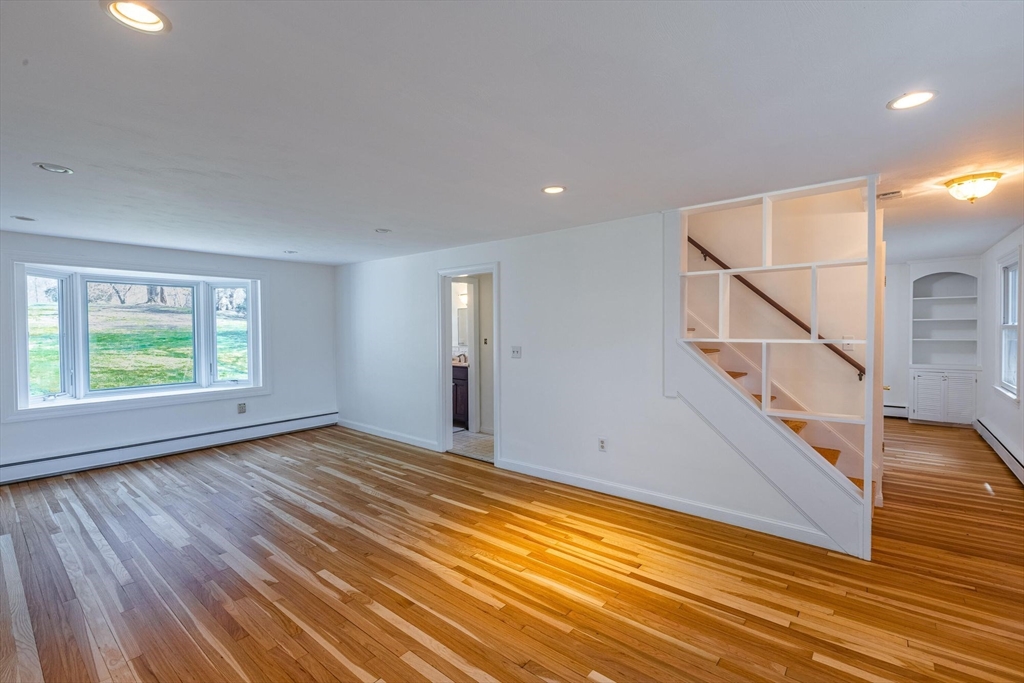 41 Labor In Vain Road Ipswich, MA 01938 - Photo 10 of 33 a view of an empty room with wooden floor and stairs