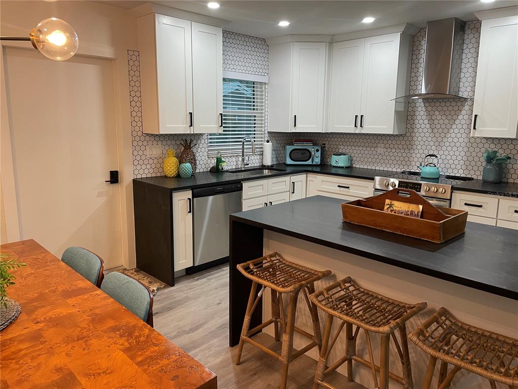 1920 Morrill Street, Unit PINEAPPLE Sarasota, FL 34236 - Photo 11 of 37 a kitchen with stainless steel appliances granite countertop a stove a sink and a refrigerator