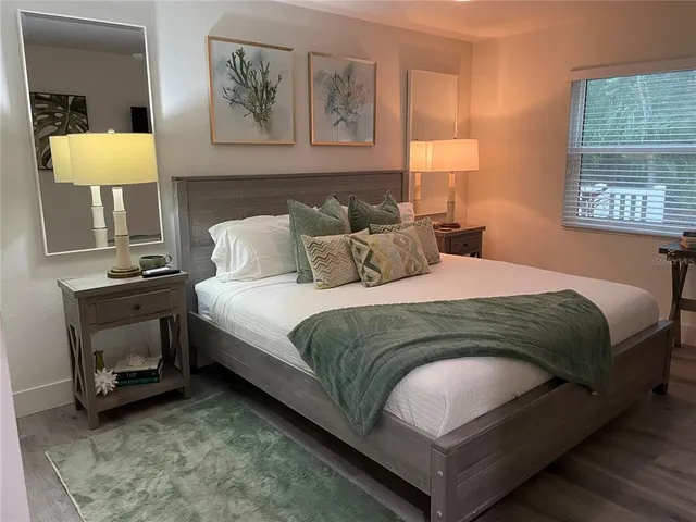 a bedroom with a bed and a lamp on table