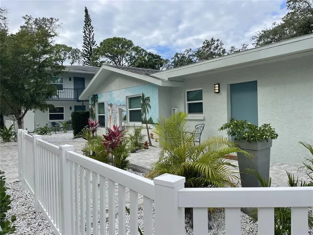a front view of house with deck and seating space