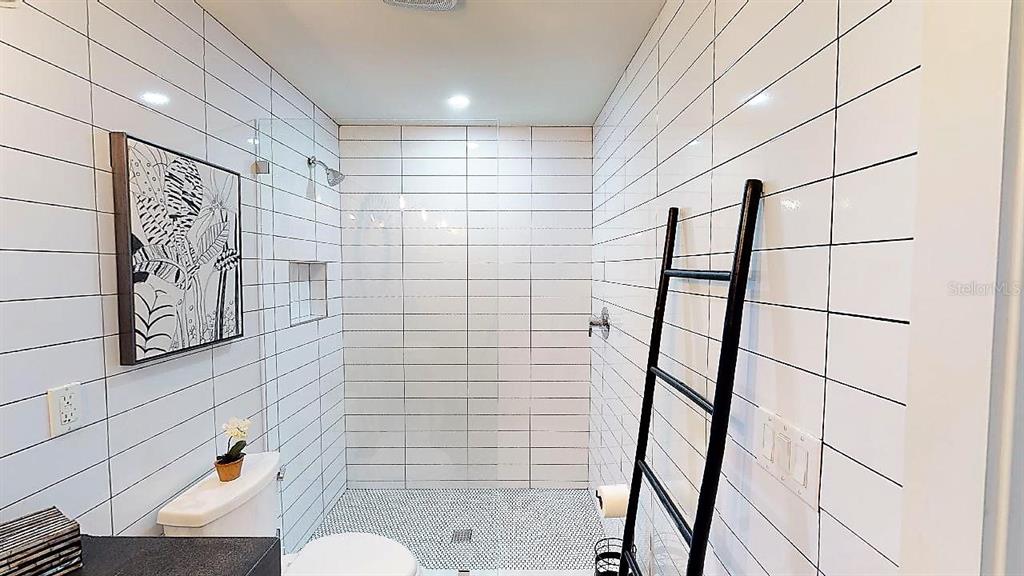 1920 Morrill Street, Unit PINEAPPLE Sarasota, FL 34236 - Photo 18 of 37 a bathroom with a shower toilet and sink