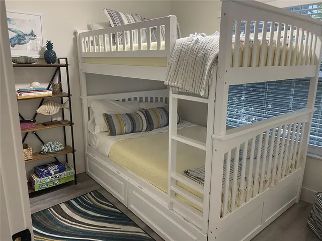 a bedroom with a bed and a book shelf