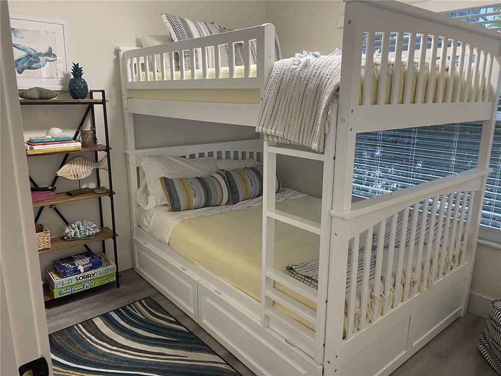 1920 Morrill Street, Unit PINEAPPLE Sarasota, FL 34236 - Photo 24 of 37 a bedroom with a bed and a book shelf