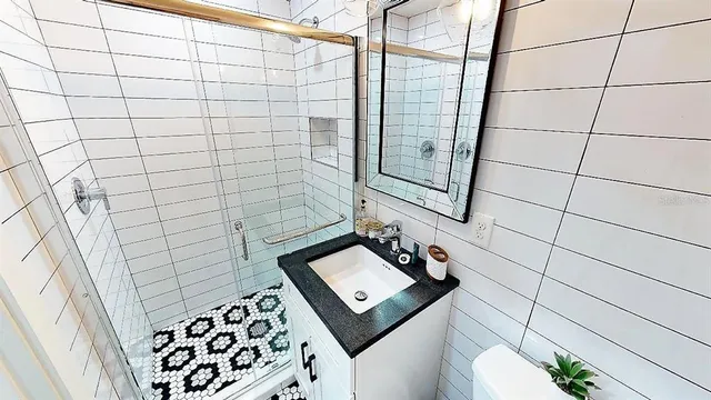 a bathroom with a toilet sink and mirror