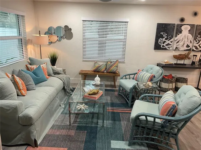 a living room with furniture and wooden floor