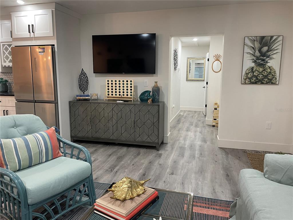 1920 Morrill Street, Unit PINEAPPLE Sarasota, FL 34236 - Photo 7 of 37 a living room with furniture and a flat screen tv