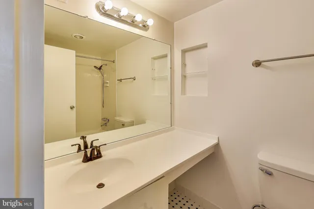 a bathroom with a tub a sink and shower