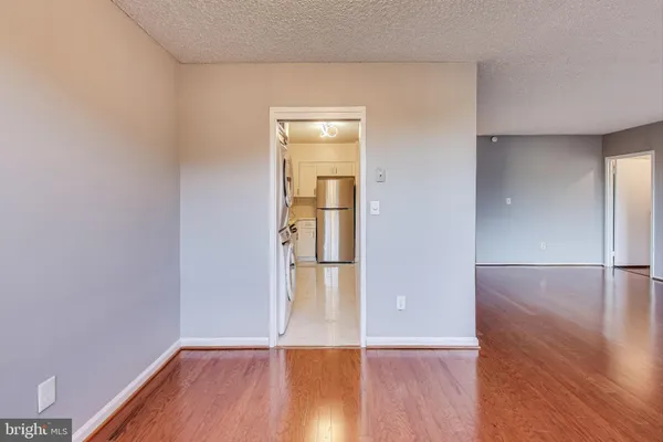 a view of empty room with wooden floor