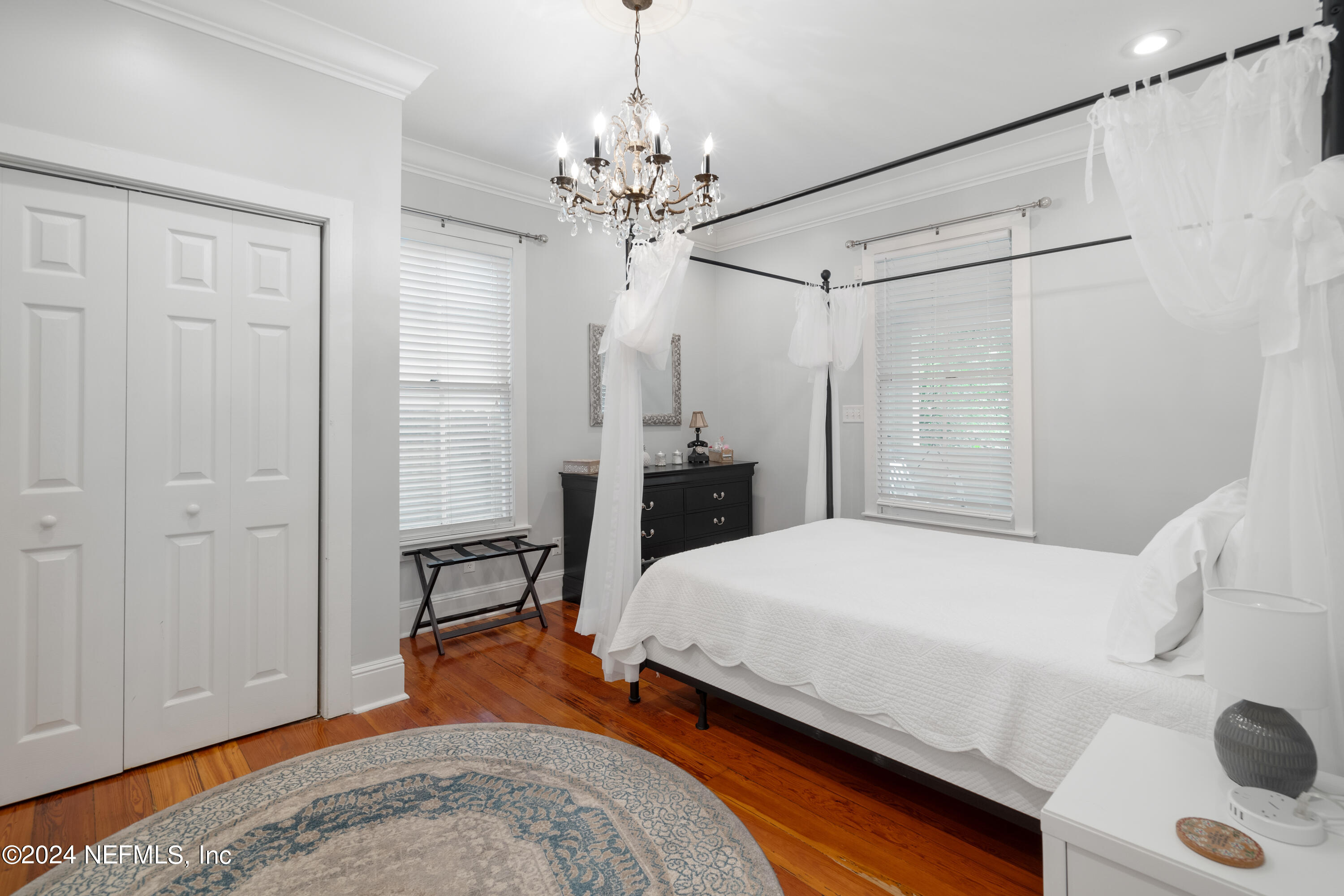 15 Rohde Avenue St. Augustine, FL 32084 - Photo 17 of 36 a bedroom with a bed and a chandelier