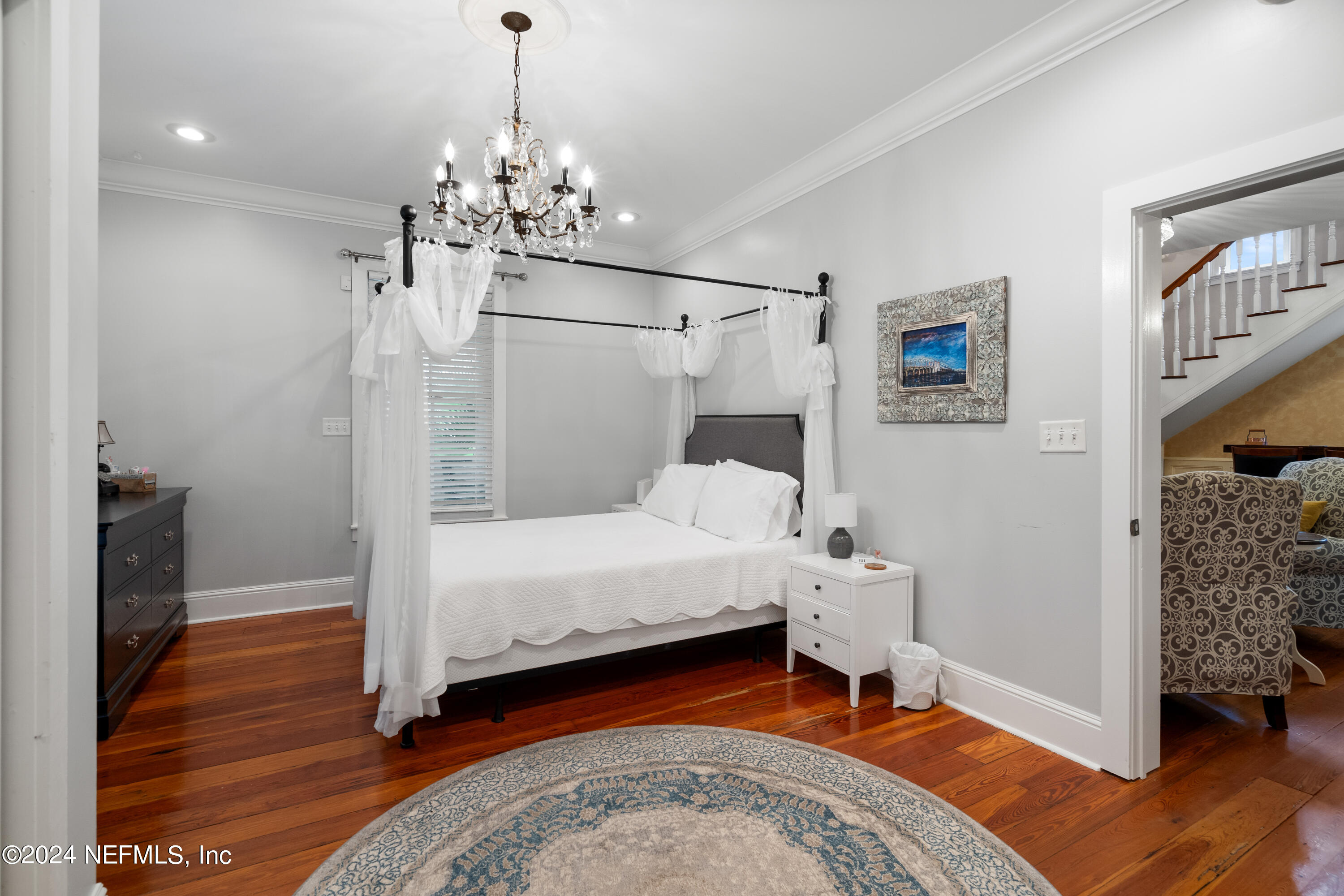 15 Rohde Avenue St. Augustine, FL 32084 - Photo 18 of 36 a bed room with a bed and a chandelier