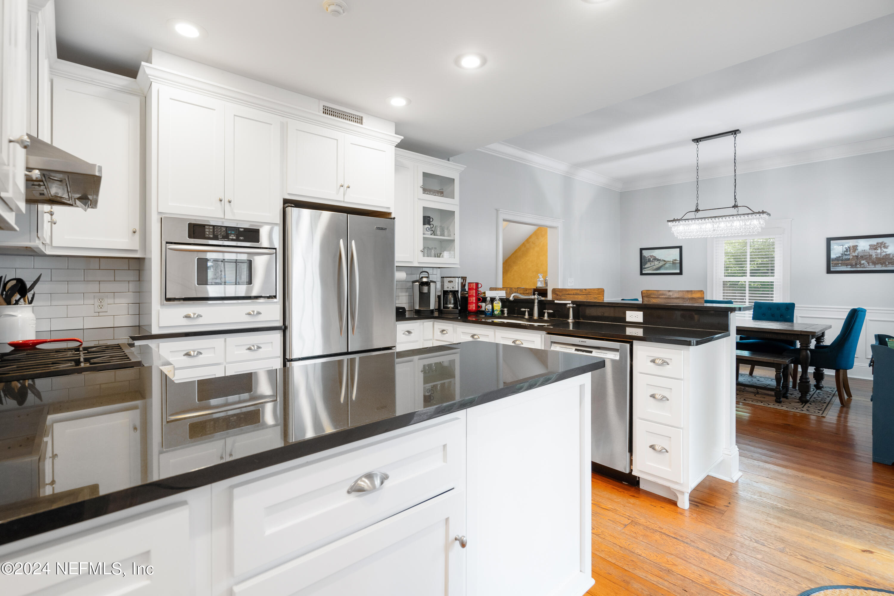 15 Rohde Avenue St. Augustine, FL 32084 - Photo 23 of 36 a kitchen with white cabinets and stainless steel appliances