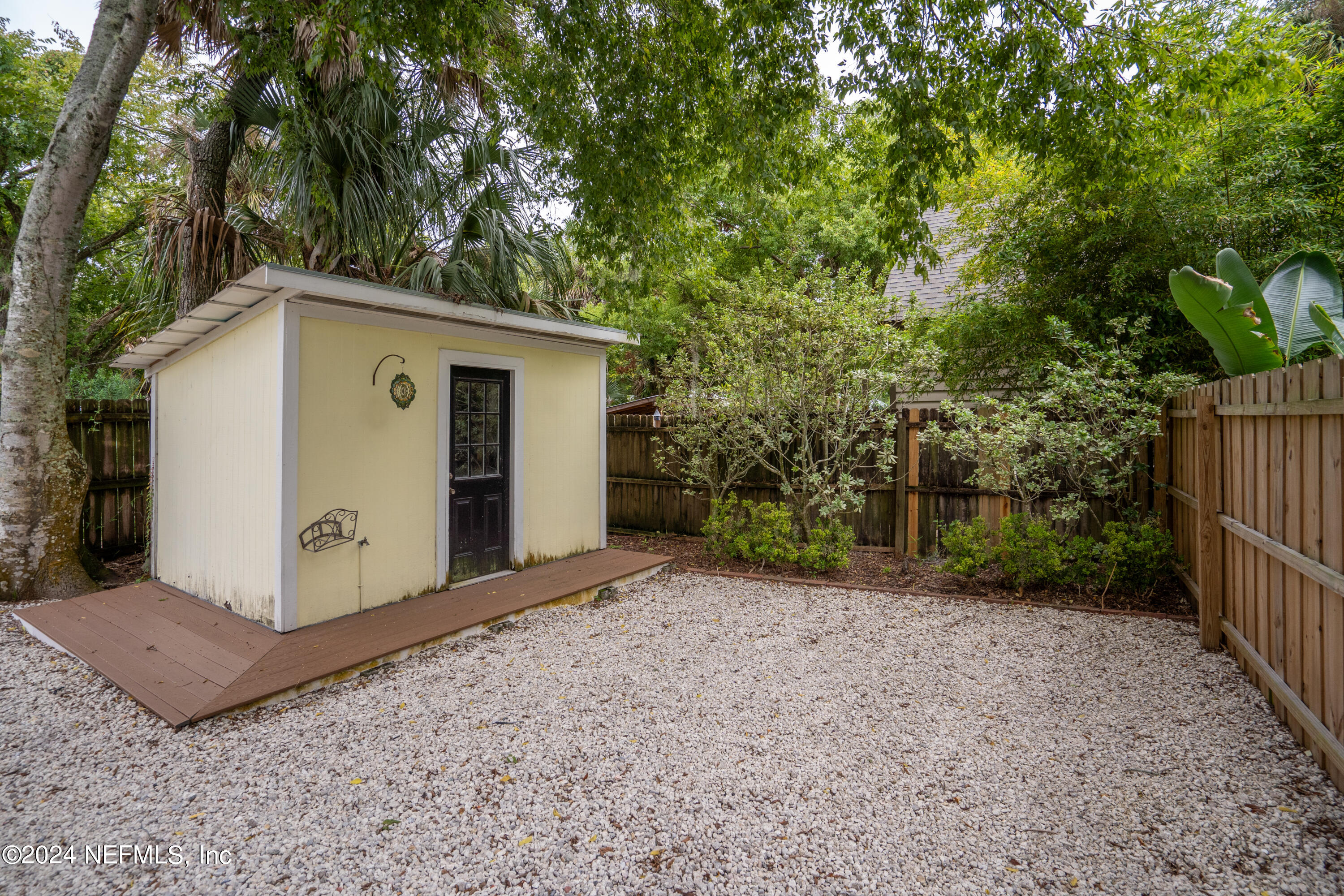 15 Rohde Avenue St. Augustine, FL 32084 - Photo 8 of 36 a view of a small space with a tree and wooden fence