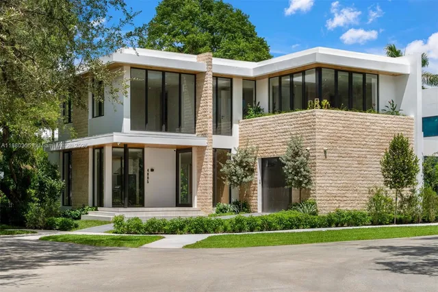 a front view of a house with a garden