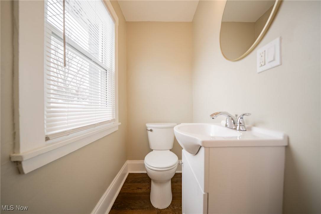 3816 Summit Park Road Cleveland Heights, OH 44121 - Photo 9 of 35 Half bathroom featuring vanity and dark wood-style floors