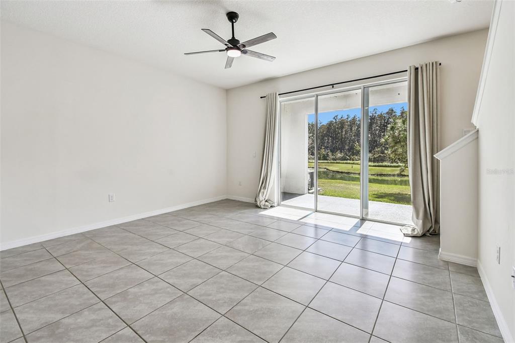 32173 Turtle Grace Loop Wesley Chapel, FL 33545 - Photo 14 of 41 a view of an empty room and window a ceiling fan