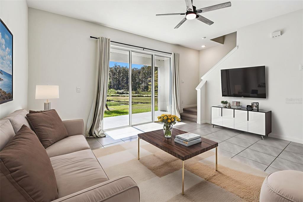 32173 Turtle Grace Loop Wesley Chapel, FL 33545 - Photo 15 of 41 a living room with furniture and a flat screen tv