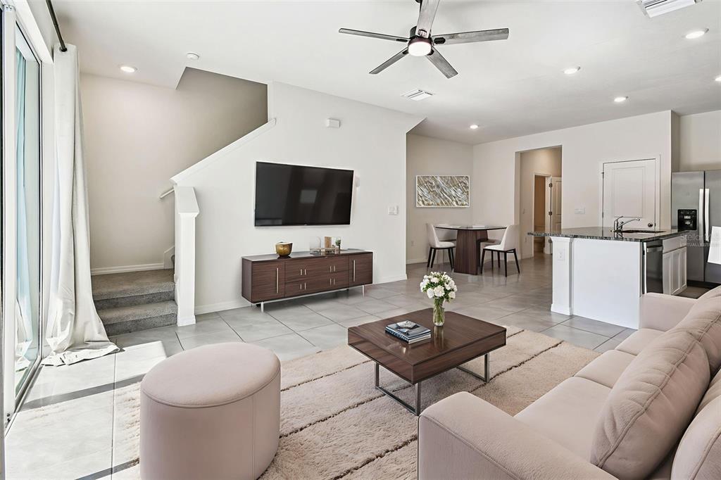 32173 Turtle Grace Loop Wesley Chapel, FL 33545 - Photo 17 of 41 a living room with furniture and a flat screen tv