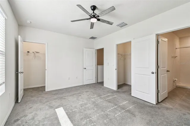 a view of a livingroom with a ceiling fan and entryway