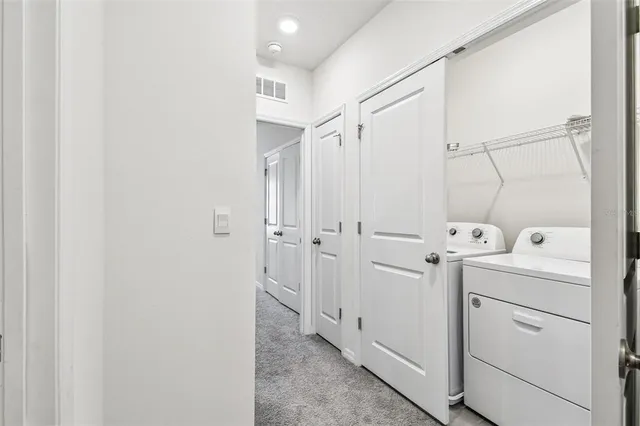 a bathroom with a granite countertop sink a toilet a mirror and shower