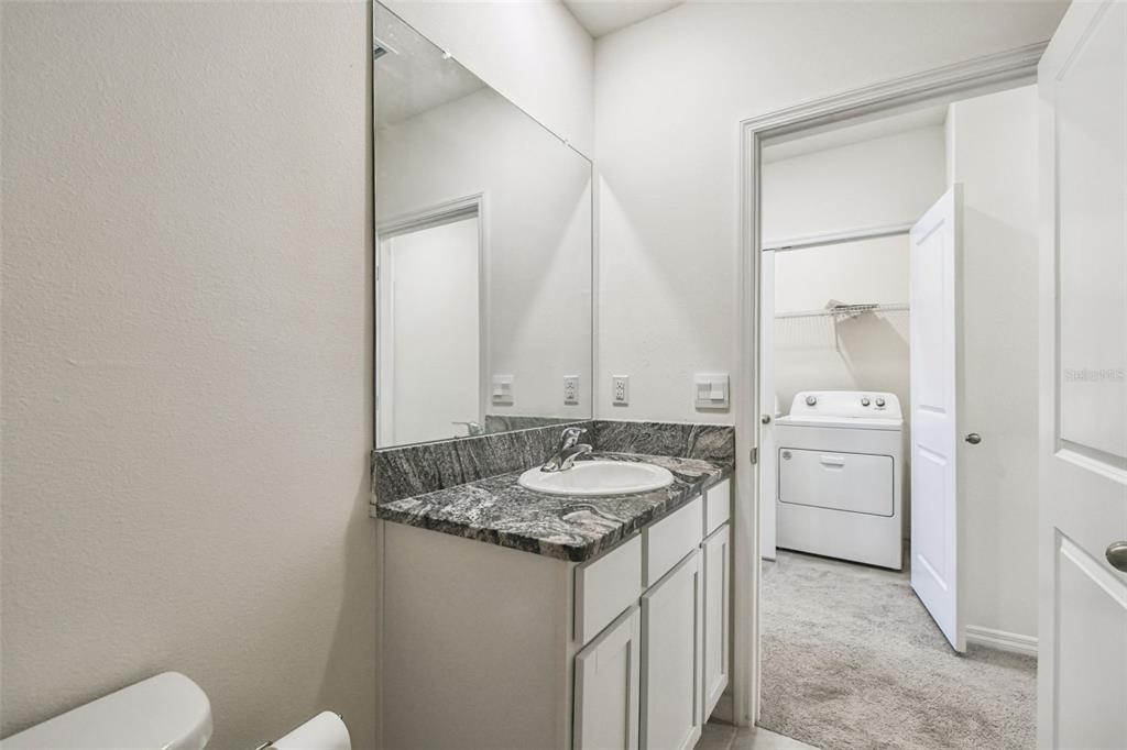 32173 Turtle Grace Loop Wesley Chapel, FL 33545 - Photo 28 of 41 a bathroom with a granite countertop sink and a mirror