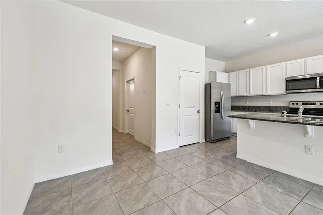 a view of a kitchen with a sink and a refrigerator