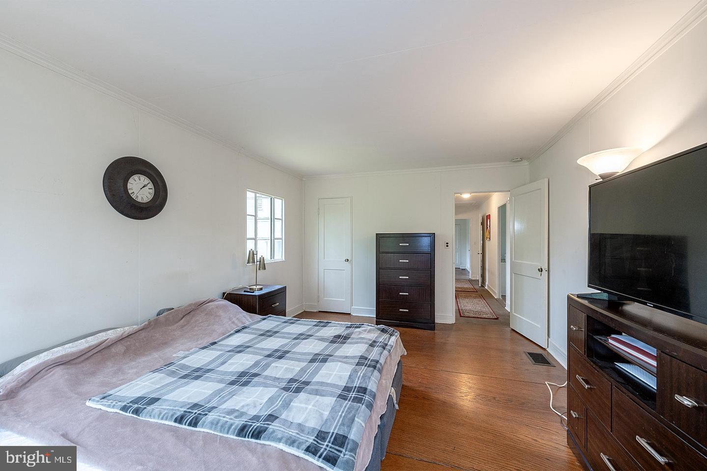 9120 Levelle Drive Chevy Chase, MD 20815 - Photo 8 of 17 a bedroom with a bed and a television