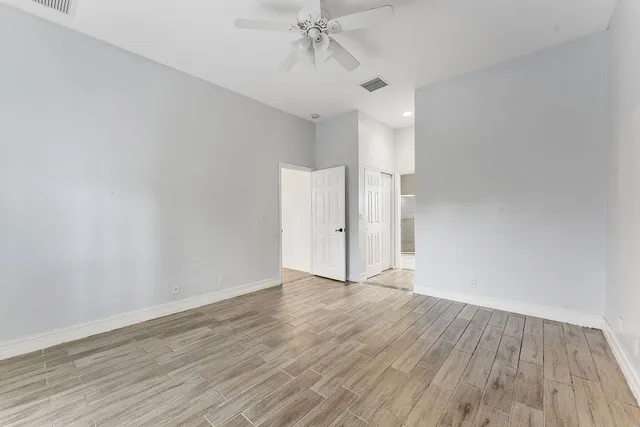 a view of an empty room and wooden floor
