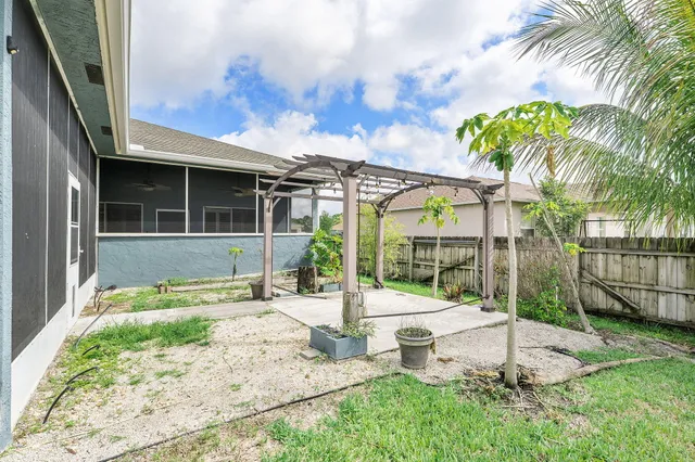 a view of a backyard with garden and patio
