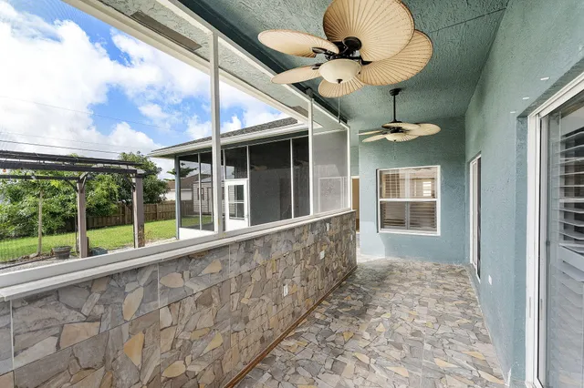 a view of a porch with a table and chairs