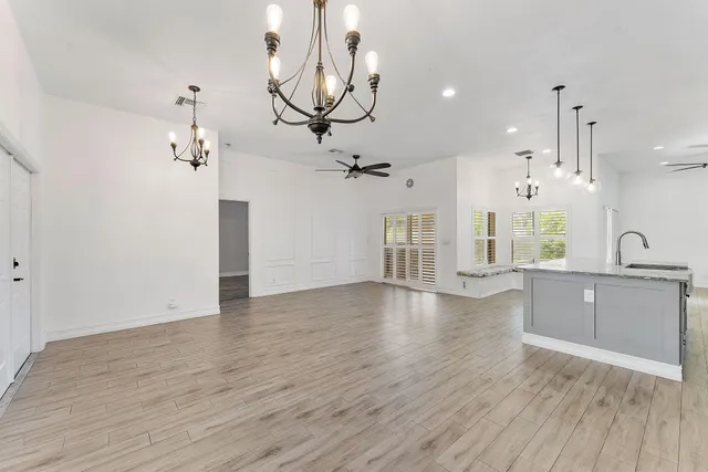 a view of a kitchen with a sink and wooden floor